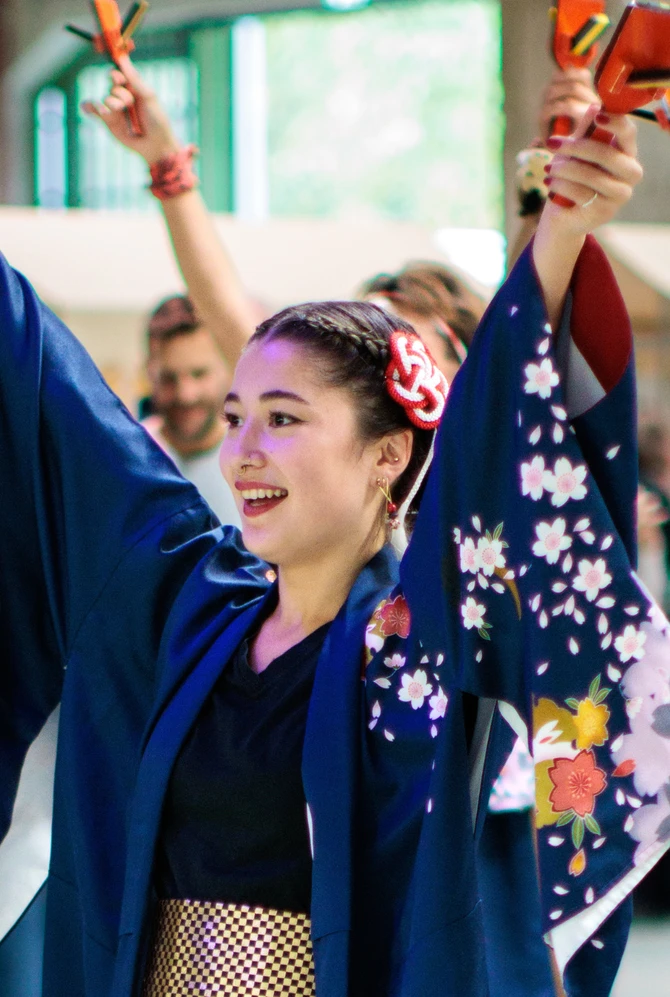 Performers in traditional Japanese-inspired costumes dance with naruko clappers at Fenix.