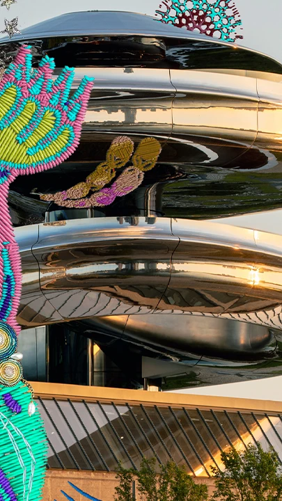 Embroidery of a tiger with geometric patterns in pink, blue, and green in front of Fenix