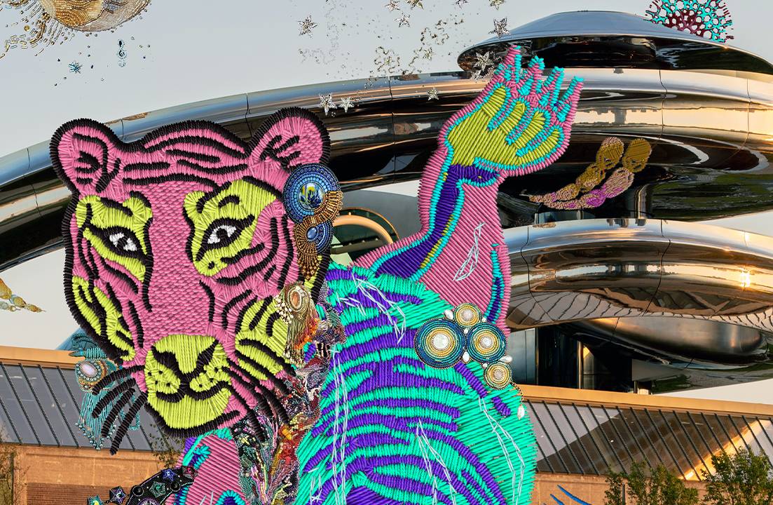 Embroidery of a tiger with geometric patterns in pink, blue, and green in front of Fenix