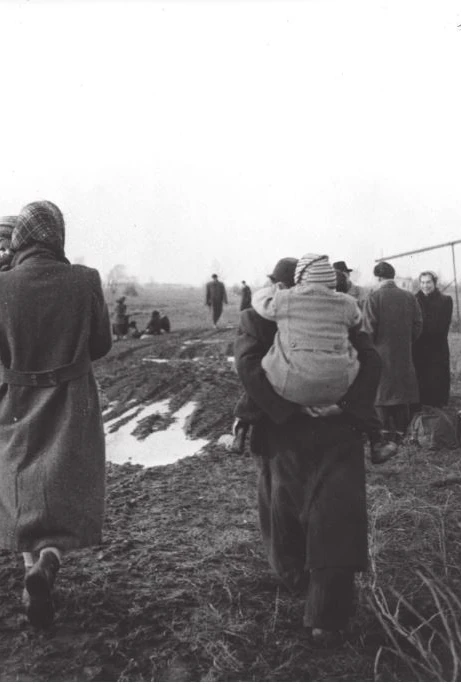 Hungarian refugees walk along a muddy path near the Austrian border in 1956.