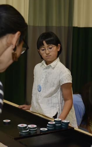 A child plays a tabletop game during CAMERA JAPAN.