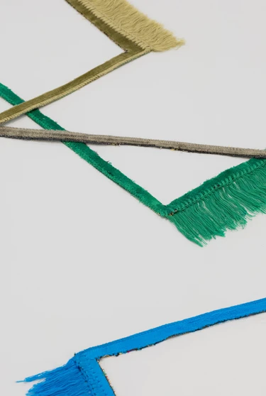 colourful frames of prayer mats are layered over eachother on white background