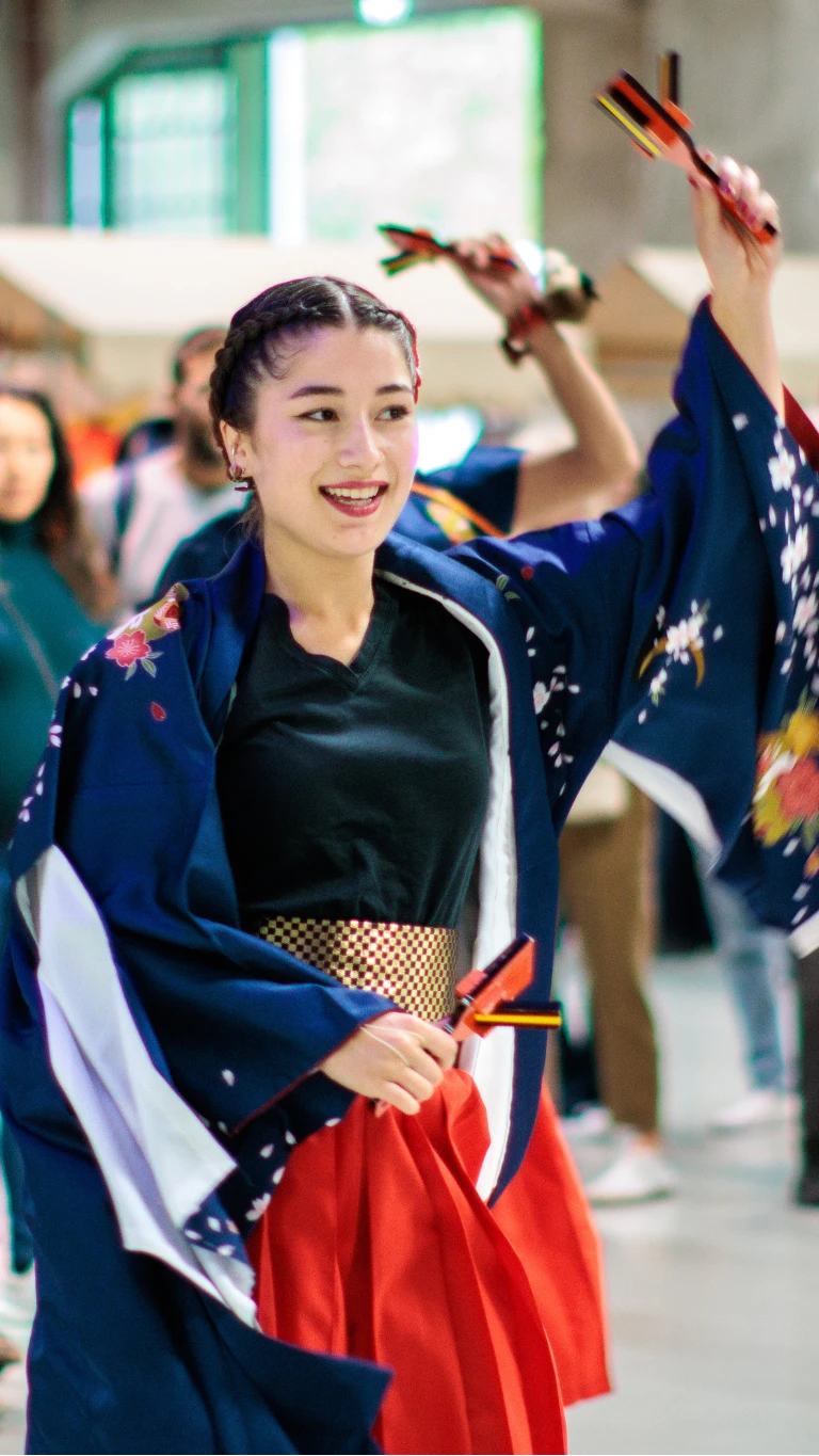 Performers in traditional Japanese-inspired costumes dance with naruko clappers at Fenix.