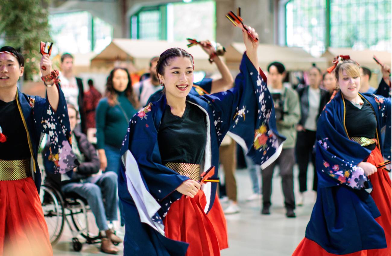 Performers in traditional Japanese-inspired costumes dance with naruko clappers at Fenix.