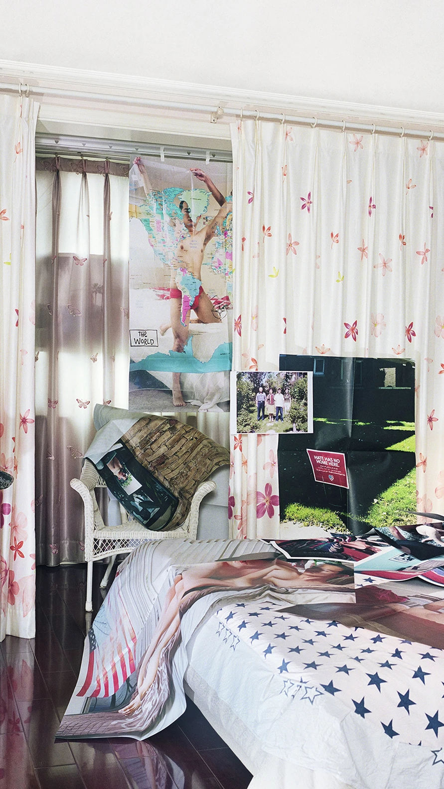 Bedroom filled with layered photographs and collages.