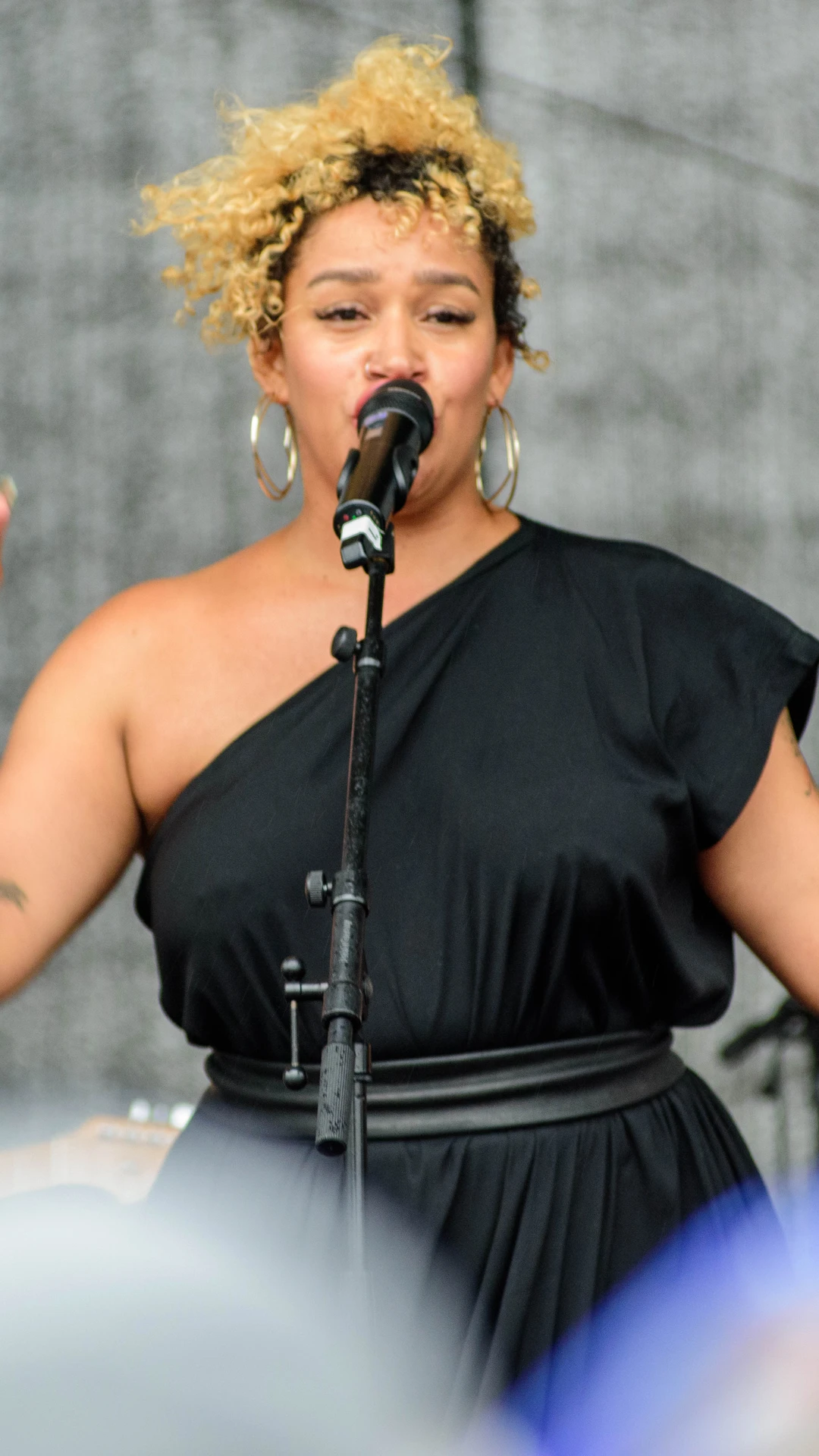 A vocalist and guitarist perform during Morabeza with the audience seated in front.